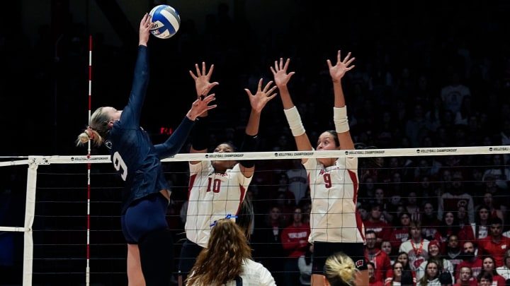 Wisconsin opposite Devyn Robinson (10) and middle blocker Caroline Crawford (9) attempt to block the shot from Penn State outside hitter Jess Mruzik (9) 