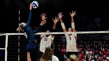 Wisconsin opposite Devyn Robinson (10) and middle blocker Caroline Crawford (9) attempt to block the shot from Penn State outside hitter Jess Mruzik (9)