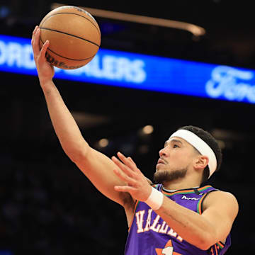 Mar 14, 2025; Phoenix, Arizona, USA; Phoenix Suns guard Devin Booker (1) shoots the ball against the Sacramento Kings during the first half at Footprint Center. Mandatory Credit: Mark J. Rebilas-Imagn Images
