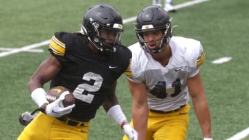 Iowa Hawkeyes running back Kaleb Johnson (2) is defended by linebacker Jaden Harrell (41) during an open spring practice Saturday, April 20, 2024 at Kinnick Stadium in Iowa City, Iowa.