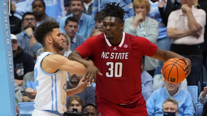 UNC basketball forward Pete Nance and NC State's DJ Burns