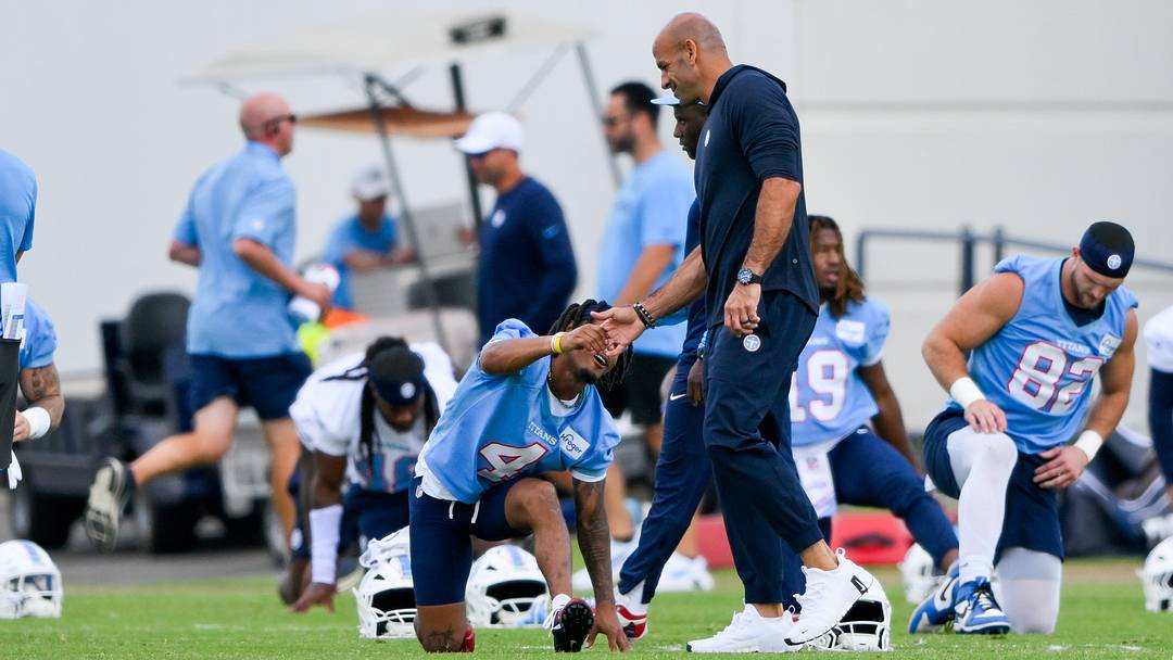 Jun 16, 2026; Nashville, TN, USA;  Tennessee Titans head coach Robert Saleh slaps hands with wide receiver Wan'Dale Robinson (4) during day 1 of mini-camp at Vanderbilt Health Football Center. Mandatory Credit: Steve Roberts-Imagn Images
