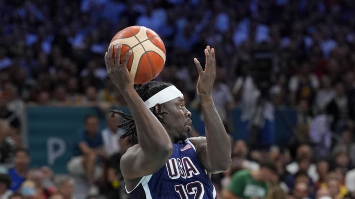 Jul 28, 2024; Villeneuve-d'Ascq, France; United States guard Jrue Holiday (12) passes in the first quarter against Serbia during the Paris 2024 Olympic Summer Games at Stade Pierre-Mauroy. Mandatory Credit: John David Mercer-USA TODAY Sports