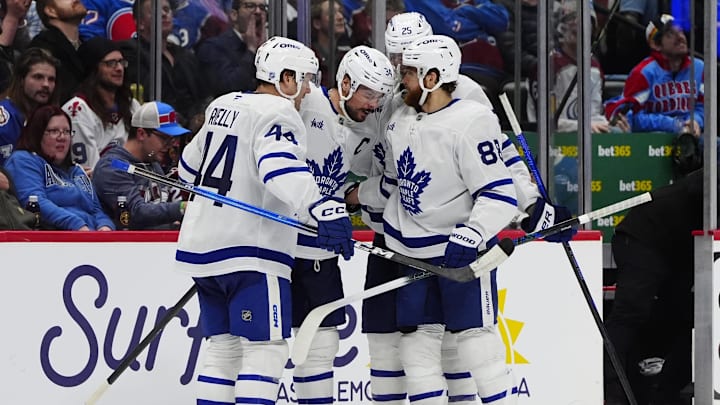Jan 12, 2026; Denver, Colorado, USA; Toronto Maple Leafs center Auston Matthews (34) celebrates his goal with defenseman Morgan Rielly (44),right wing William Nylander (88), and defenseman Brandon Carlo (25) in the third period against the Colorado Avalanche at Ball Arena. Mandatory Credit: Ron Chenoy-Imagn Images