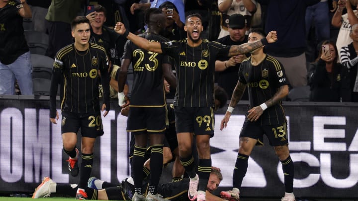 Jul 30, 2024; Los Angeles, California, USA;  LAFC forward Denis Bouanga (99) celebrates a game tying goal by midfielder Mateusz Bogusz (19, bottom) during the second half against Vancouver Whitecaps FC at BMO Stadium. Mandatory Credit: Kiyoshi Mio-USA TODAY Sports