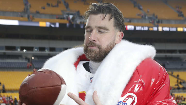 Travis Kelce considers a football shaped cake on Christmas. Travis Kelce considers a football shaped cake on Christmas.