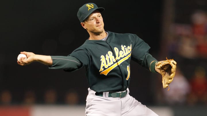 May 10, 2011; Arlington, TX, USA; Oakland Athletics second baseman Mark Ellis (14) throws to first base against the Texas Rangers at Rangers Ballpark in Arlington. The Rangers won 7-2. Mandatory Credit: Jim Cowsert-USA TODAY Sports