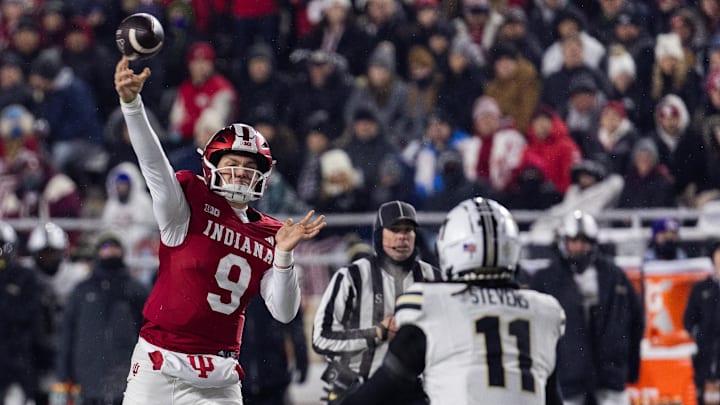Indiana Hoosiers quarterback Kurtis Rourke passes the ball while Purdue Boilermakers defensive back Antonio Stevens defends 