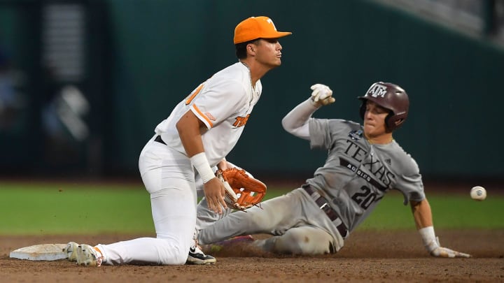 Texas A&M's Jackson Appel (20) slides safely into second base during a NCAA College World Series game between Tennessee and Texas A&M at Charles Schwab Field in Omaha, Neb., on Saturday, June 22, 2024.
