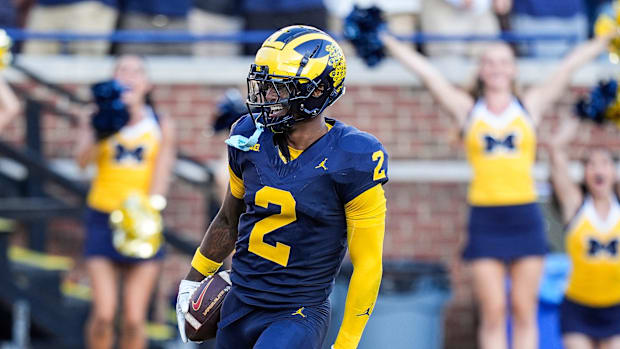 Michigan defensive back Will Johnson celebrates a touchdown after intercepting USC quarterback Miller Moss. 