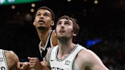 Jan 17, 2024; Boston, Massachusetts, USA; Boston Celtics forward Jayson Tatum (0) and center Luke Kornet (40) box out San Antonio Spurs center Victor Wembanyama (1) during the second half at TD Garden.