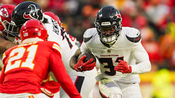 Jan 18, 2025; Kansas City, Missouri, USA; Houston Texans running back Dameon Pierce (31) runs the ball against Kansas City Chiefs safety Jaden Hicks (21) during the second half in a 2025 AFC divisional round game at GEHA Field at Arrowhead Stadium. Mandatory Credit: Jay Biggerstaff-Imagn Images