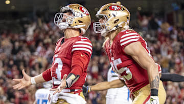 December 30, 2024; Santa Clara, California, USA; San Francisco 49ers quarterback Brock Purdy (13) celebrates with tight end George Kittle (85) after scoring a touchdown against the Detroit Lions during the second quarter at Levi's Stadium. Mandatory Credit: Kyle Terada-Imagn Images