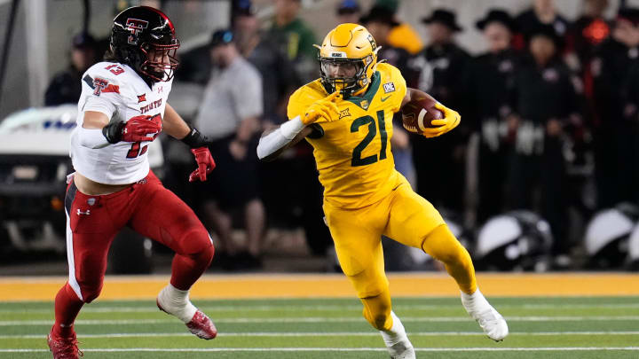 Oct 7, 2023; Waco, Texas, USA; Baylor Bears running back Dominic Richardson (21) runs the ball as a Texas Tech defender comes to tackle him.