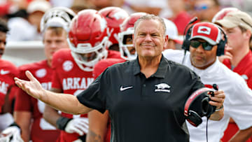 Arkansas Razorback head coach Sam Pittman (front) and defensive line coach Deke Adams watch from the sidelines in Arkansas' 56-14 win over the Arkansas State Red Wolves at War Memorial Stadium in Little Rock