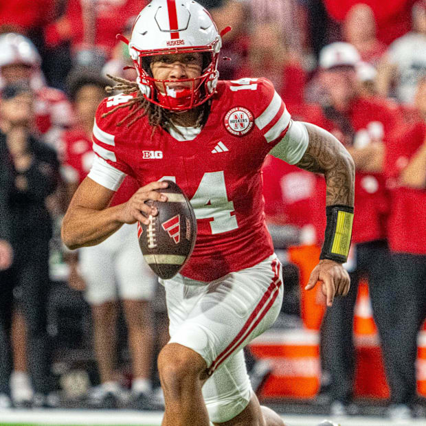 Nebraska quarterback TJ Lateef scrambles for yardage,