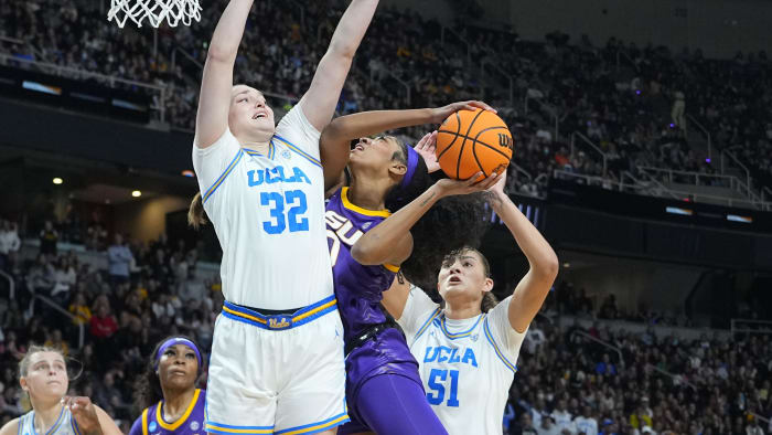 Mar 30, 2024; Albany, NY, USA; LSU Tigers forward Angel Reese (10) shoots a layup against UCLA bigs Angela Dugalic (32) and Lauren Betts (51).