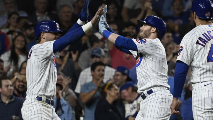 Sep 20, 2023; Chicago, Illinois, USA; Chicago Cubs left fielder Ian Happ (8), right, celebrates his grand slam against the Pittsburgh Pirates with Chicago Cubs second baseman Nico Hoerner (2), left, during the fifth inning at Wrigley Field.