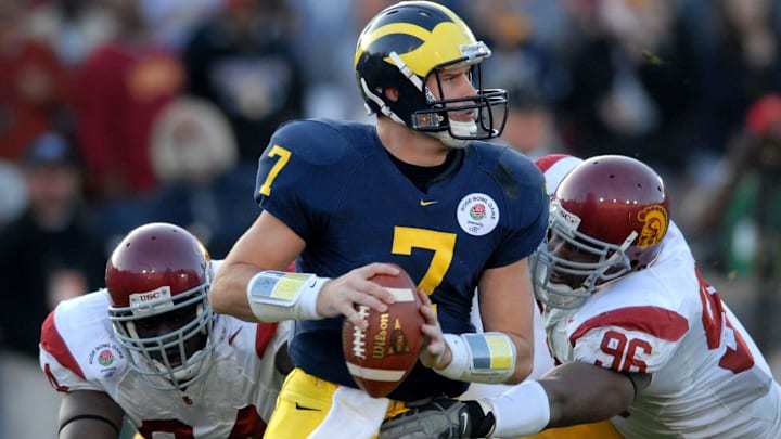 Jan 1, 2007; Pasadena, CA, USA; Michigan Wolverines quarterback (7) Chad Henne is pressured by Southern California Trojans defensive end (96) Lawrence Jackson and defensive end (84) Kyle Moore in the third quarter during the Rose Bowl game at the Rose Bowl in Pasadena, California. Mandatory Credit: Mark J. Rebilas-Imagn Images Copyright © 2007 Mark J. Rebilas