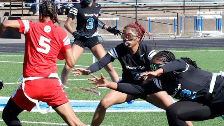 Woodlan Hills senior Atiyah Walker, right, works with teammate Scoyna Taylor, middle, to try and grab Jeannette players' flag during an April game at Woodland Hills High School. Walker was one of the players chosen for the Steelers' team to play in the Big 33 Classic later this month. Woodlan Hills senior Atiyah Walker, right, works with teammate Scoyna Taylor, middle, to try and grab Jeannette players' flag during an April game at Woodland Hills High School. Walker was one of the players chosen for the Steelers' team to play in the Big 33 Classic later this month.