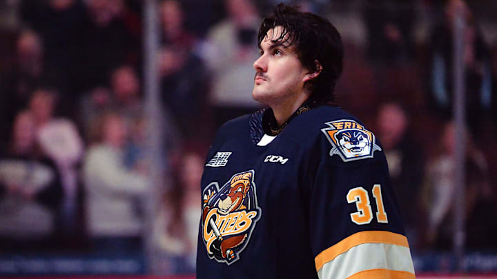 Erie Otters goaltender Ethan Fraser listens to the Canadian national anthem prior to an Ontario Hockey League game against the London Knights at Erie Insurance Arena in Erie on March 13, 2024.