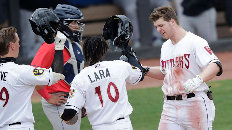 Wisconsin Timber Rattlers' Luke Adams, right, celebrates hitting a homerun against the Cedar Rapids Kernels during their baseball game Wednesday, April 17, 2024, at Neuroscience Group Field at Fox Cities Stadium in Grand Chute, Wisconsin.