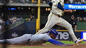 Oct 1, 2024; Milwaukee, Wisconsin, USA; New York Mets second base Jose Iglesias (11) slides safely for a hit against Milwaukee Brewers pitcher Joel Payamps (31) during the fifth inning in game one of the Wildcard round for the 2024 MLB Playoffs at American Family Field. Mandatory Credit: Benny Sieu-Imagn Images