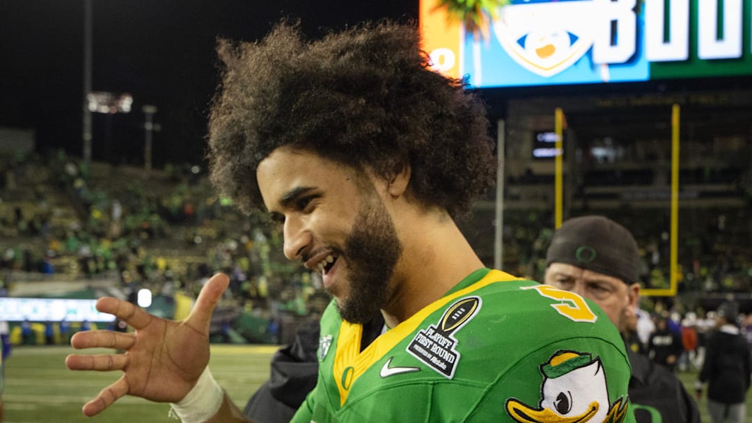 Oregon quarterback Dante Moore celebrates the Ducks' victory over James Madison at the end of the game at Autzen Stadium in Eugene Dec. 20, 2025.