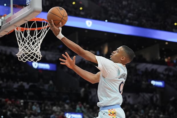 San Antonio Spurs forward Keldon Johnson (0) lays the ball up in front of Atlanta Hawks forward Larry Nance Jr. (22) in the s
