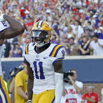 Sep 30, 2023; Oxford, Mississippi, USA; LSU Tigers wide receiver Brian Thomas Jr. (11) reacts with LSU Tigers wide receiver Malik Nabers (8) after a touchdown during the first half at Vaught-Hemingway Stadium. Mandatory Credit: Petre Thomas-Imagn Images
