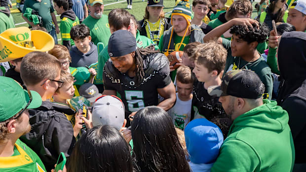 Combat Ducks running back Noah Whittington signs autographs amid a mob of fans as the Fighting Ducks face off against Mighty 