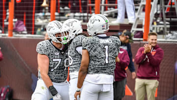 Nov 22, 2025; Blacksburg, Va.; Virginia Tech offensive lineman Johnny Garrett (79) and quarterback Kyron Drones (1) celebrate with running back Jeffrey Overton (16).