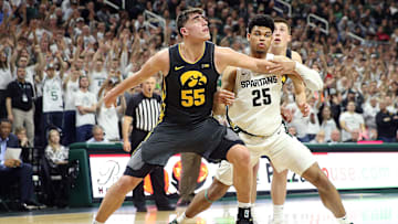 Feb 25, 2020; East Lansing, Michigan, USA; Iowa Hawkeyes center Luka Garza (55) and Michigan State Spartans forward Malik Hall (25) fight for position during the second half a game at the Breslin Center. Mandatory Credit: Mike Carter-Imagn Images