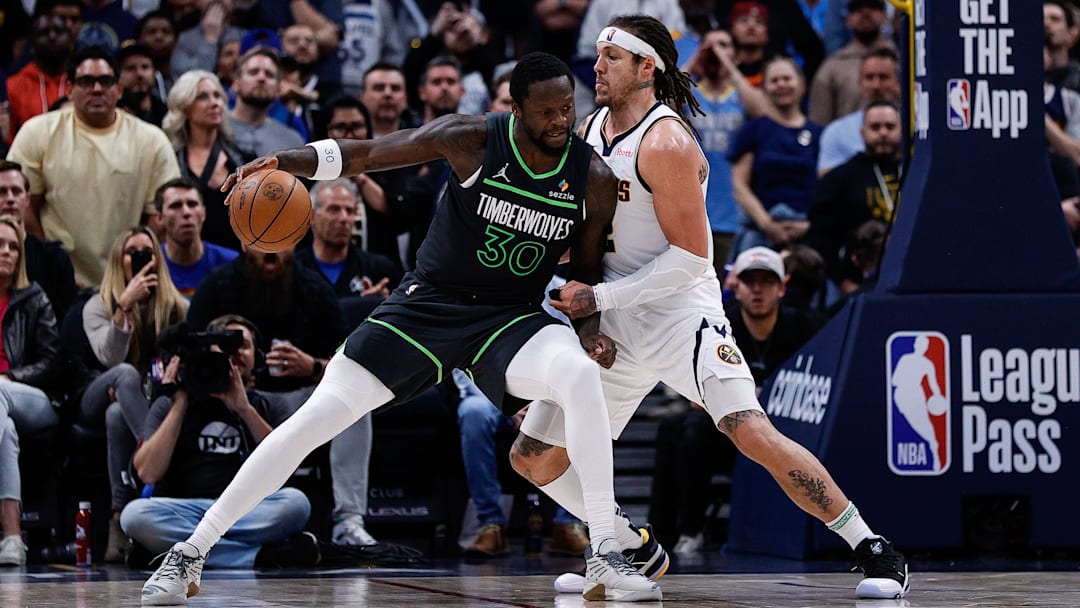 Apr 1, 2025; Denver, Colorado, USA; Minnesota Timberwolves forward Julius Randle (30) controls the ball against Denver Nuggets forward Aaron Gordon (32) in overtime at Ball Arena. Mandatory Credit: Isaiah J. Downing-Imagn Images