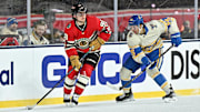 Dec 31, 2024; Chicago, Illinois, USA; Chicago Blackhawks center Connor Bedard (98) skates with the puck against St. Louis Blues center Jordan Kyrou (25) during the third period in the Winter Classic at Wrigley Field. Mandatory Credit: Daniel Bartel-Imagn Images