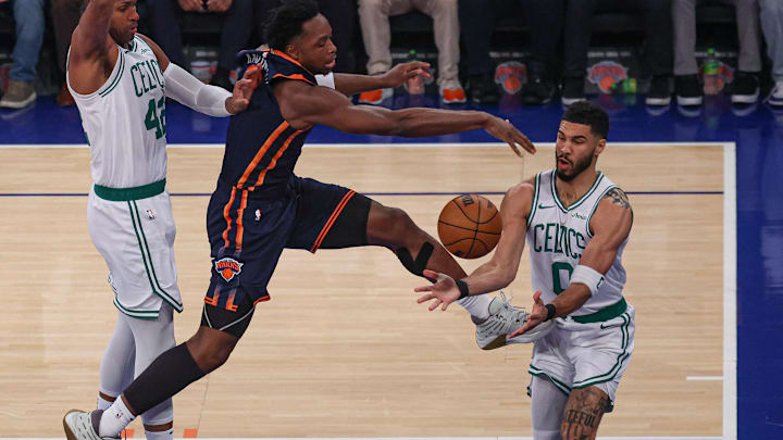 New York Knicks forward OG Anunoby loses ball near Boston Celtics players Jayson Tatum and Al Horford in the NBA Playoffs