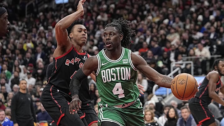 Jan 15, 2024; Toronto, Ontario, CAN; Boston Celtics guard Jrue Holiday (4) drives around Toronto Raptors forward Scottie Barnes (4) during the first half at Scotiabank Arena. Mandatory Credit: John E. Sokolowski-Imagn Images