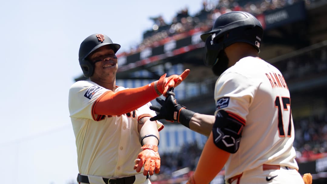 Jun 21, 2025; San Francisco, California, USA; San Francisco Giants designated hitter Rafael Devers (16) gets a congratulatory handshake from teammate Heliot Ramos (17) after hitting a two-run home run against the Boston Red Sox during the third inning at Oracle Park. 