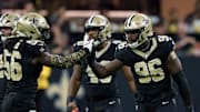 Sep 14, 2025; New Orleans, Louisiana, USA; New Orleans Saints defensive end Carl Granderson (96) reacts after tackling San Francisco 49ers quarterback Mac Jones (not shown) with linebacker Demario Davis (56) during the first half at Caesars Superdome. Mandatory Credit: Matthew Hinton-Imagn Images