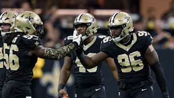 Sep 14, 2025; New Orleans, Louisiana, USA; New Orleans Saints defensive end Carl Granderson (96) reacts after tackling San Francisco 49ers quarterback Mac Jones (not shown) with linebacker Demario Davis (56) during the first half at Caesars Superdome. Mandatory Credit: Matthew Hinton-Imagn Images