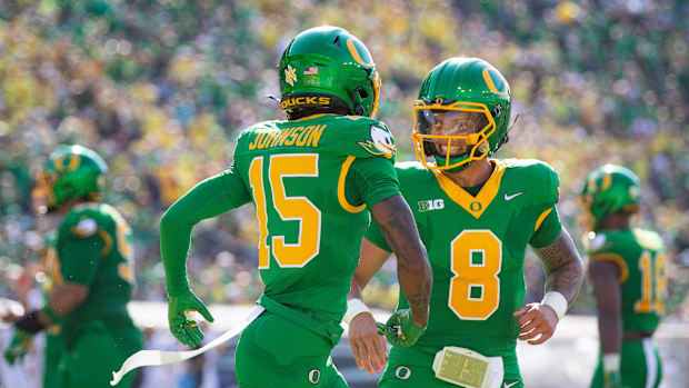 Oregon Ducks quarterback Dillon Gabriel and Oregon Ducks wide receiver Tez Johnson celebrate a touchdown by Johnson as the Or