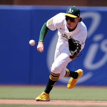 Jul 13, 2025; West Sacramento, California, USA; Athletics shortstop Jacob Wilson (5) fields a ground ball against the Toronto Blue Jays during the seventh inning at Sutter Health Park. Mandatory Credit: Dennis Lee-Imagn Images
