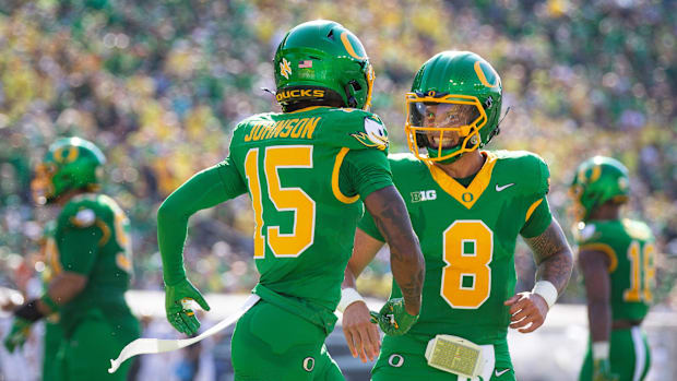 Oregon Ducks quarterback Dillon Gabriel and Oregon Ducks wide receiver Tez Johnson celebrate a touchdown by Johnson as the Or