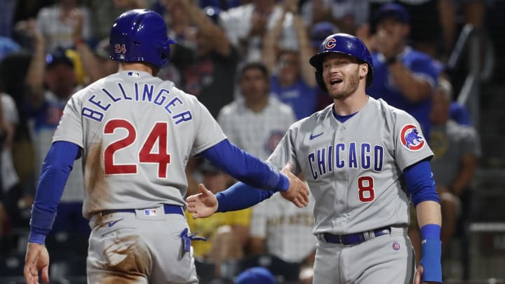 Chicago Cubs first baseman Cody Bellinger (24) and left fielder Ian Happ (8) celebrate after both players scored runs against the Pittsburgh Pirates.