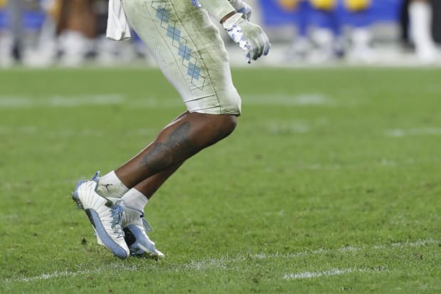 White and blue Air Jordan cleats.