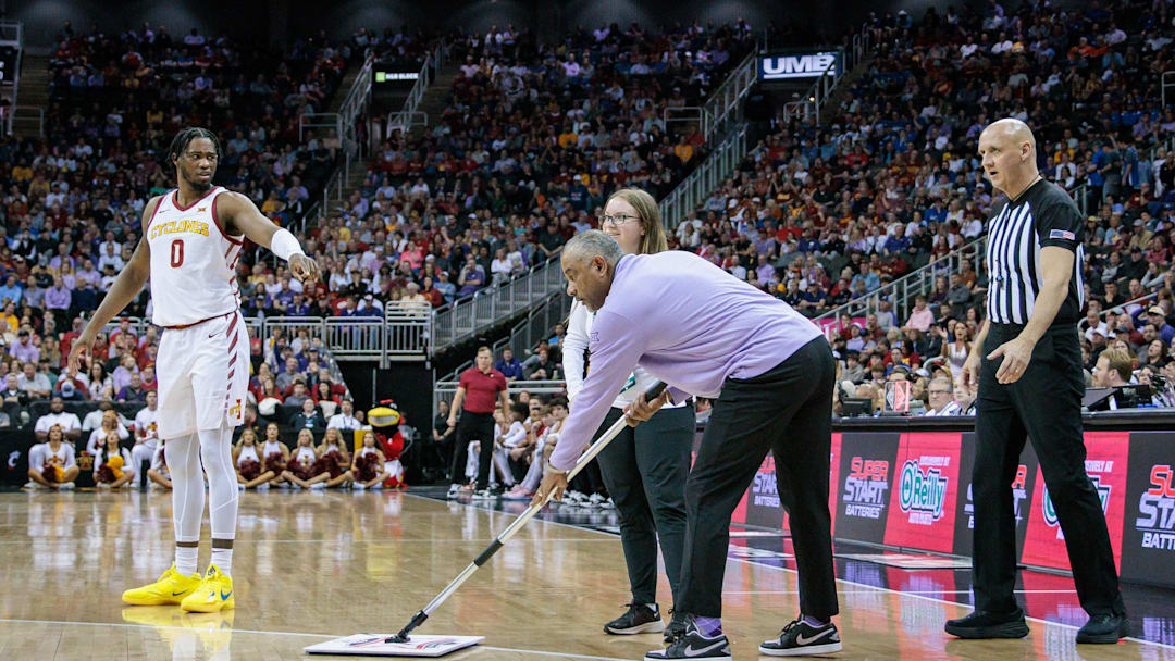 Mar 14, 2024; Kansas City, MO, USA; Kansas State Wildcats coach Jerome Tang cleans the floor during a break in play of the first half of the game Iowa State Cyclones at T-Mobile Center. Mandatory Credit: William Purnell-Imagn Images