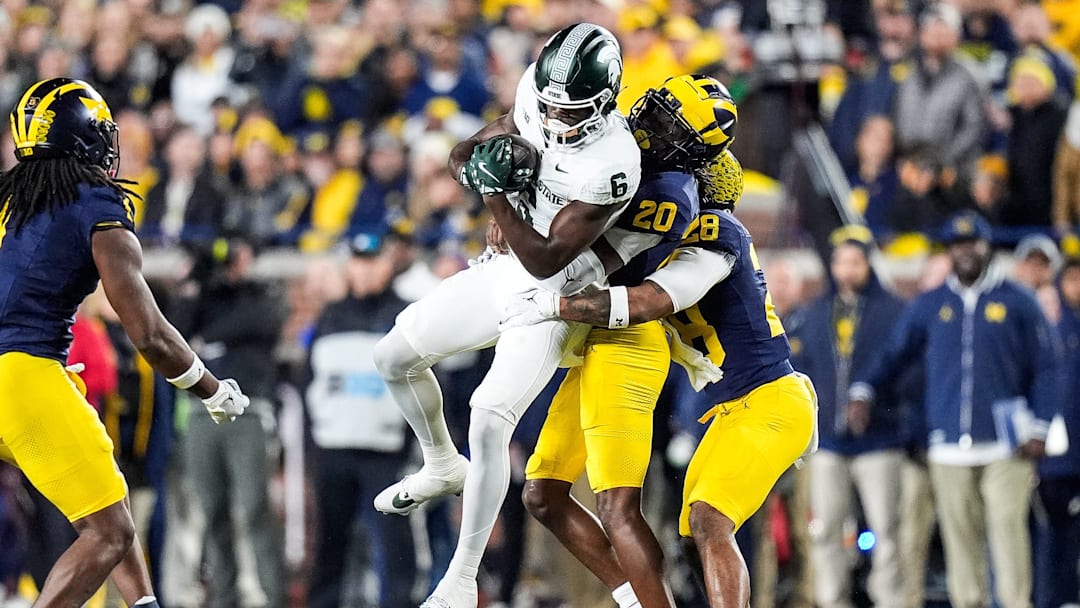 Michigan State wide receiver Nick Marsh (6) makes a catch against Michigan defensive backs Jyaire Hill (20) and Quinten Johnson (28) 