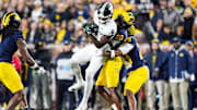 Michigan State wide receiver Nick Marsh (6) makes a catch against Michigan defensive back Jyaire Hill (20) and defensive back Quinten Johnson (28) during the first half at Michigan Stadium in Ann Arbor on Saturday, Oct. 26, 2024.