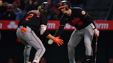 Apr 23, 2024; Anaheim, California, USA; Baltimore Orioles shortstop Gunnar Henderson (2) is greeted by catcher Adley Rutschman (35) after hitting a solo home run against the Los Angeles Angels during the seventh inning at Angel Stadium.