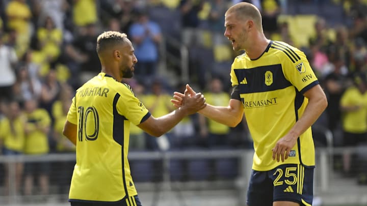 May 31, 2025; Nashville, Tennessee, USA;  Nashville SC midfielder Hany Mukhtar (10) and defender Walker Zimmerman (25) celebrates a goal by forward Sam Surridge (9) during the first half at Geodis Park. Mandatory Credit: Steve Roberts-Imagn Images